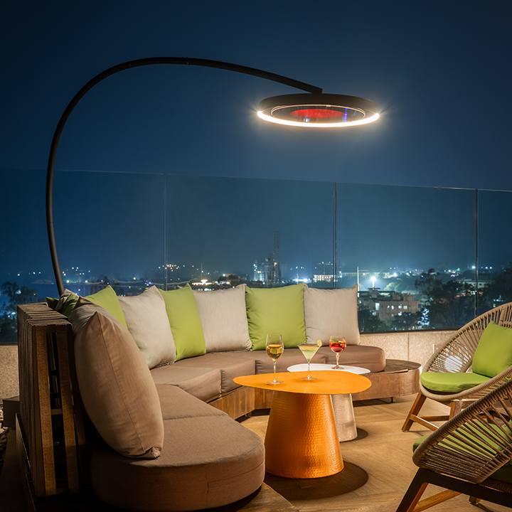 Bromic Eclipse heater on rooftop bar with nighttime city skyline