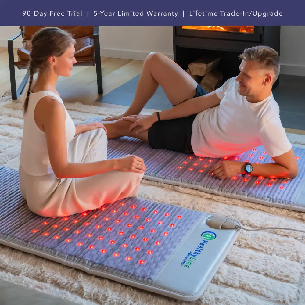 Two people using infrared heating mats in a home setting with promotional text above.
