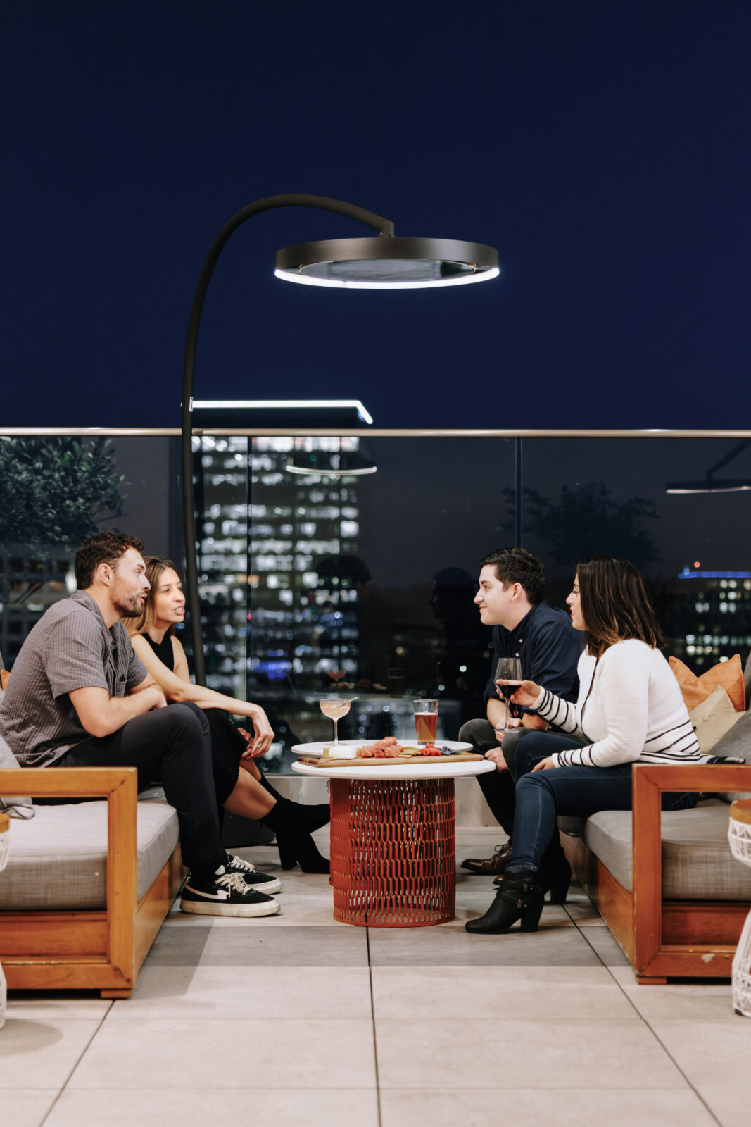 Bromic Eclipse heater on rooftop bar with nighttime city skyline