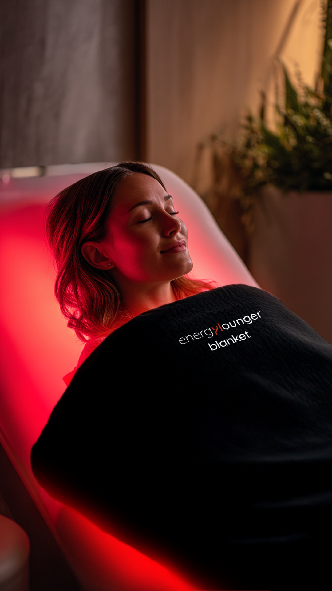 Person lying on the EnergyLounger Blanket for full-body red and NIR therapy.