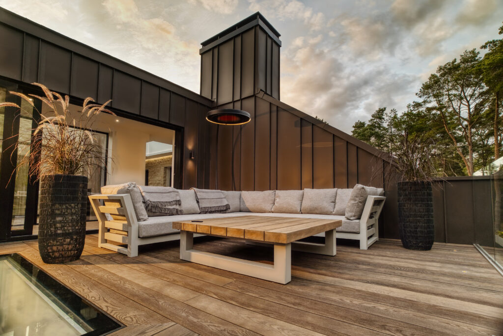Bromic Eclipse heater beside outdoor lounge seating in a modern courtyard