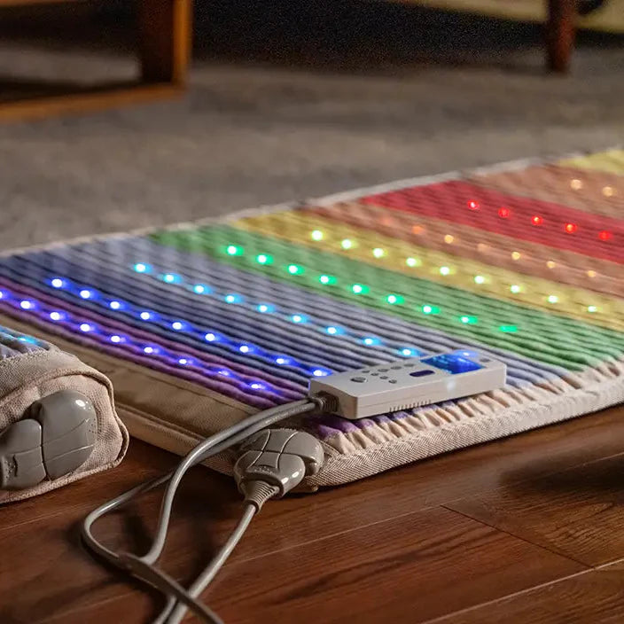 Side profile of HealthyLine Rainbow Chakra Mat 74x28 showing thickness and controller.