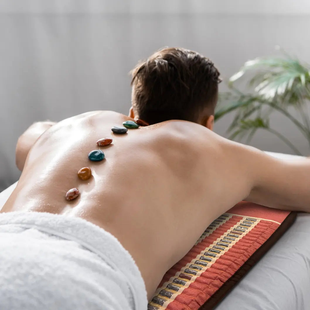 Person lying face-down on a full-length TAO mat in a home setting.