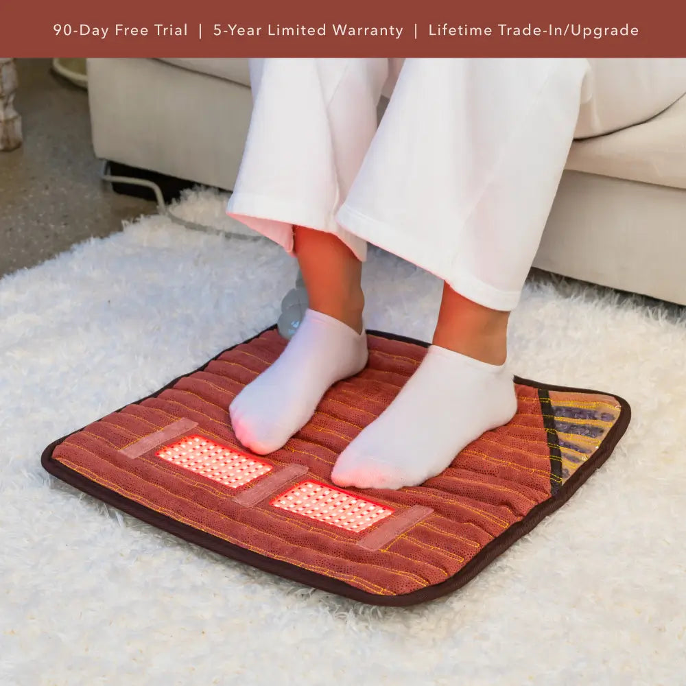 Person with both feet on a TAO mat used as a warming footpad.