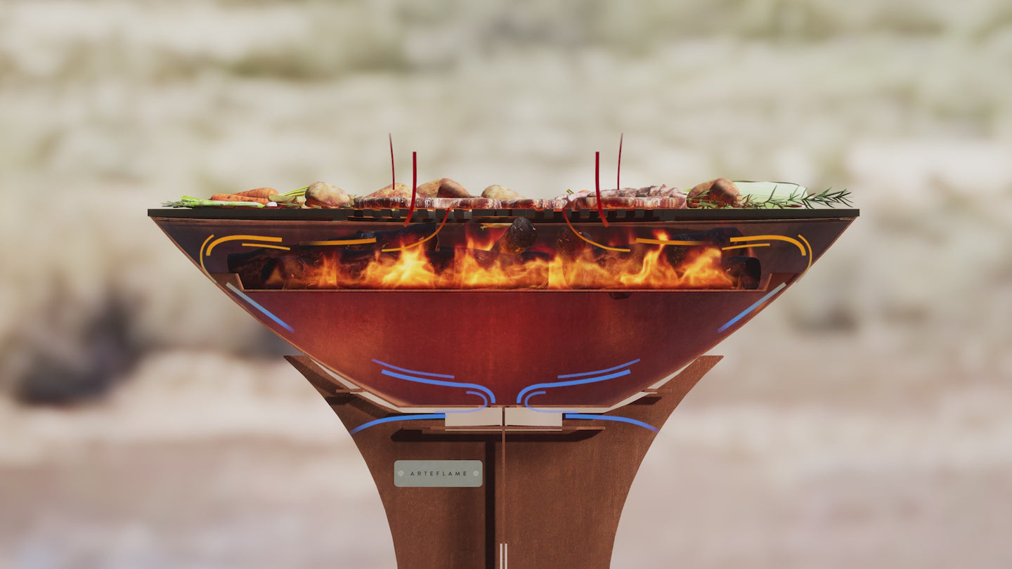 Arteflame Corten steel grill operating in an open outdoor setting with flames in the center bowl.
