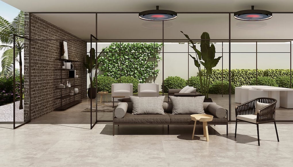 Modern outdoor living space with a sofa, chairs, and a coffee table in a garden setting.