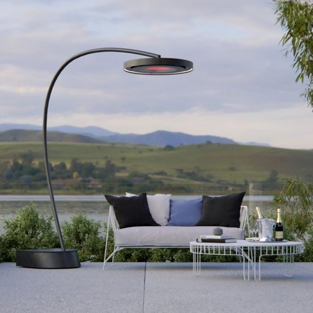 Freestanding Bromic Eclipse Smart-Heat Portable heater on a modern patio overlooking a lake at sunset