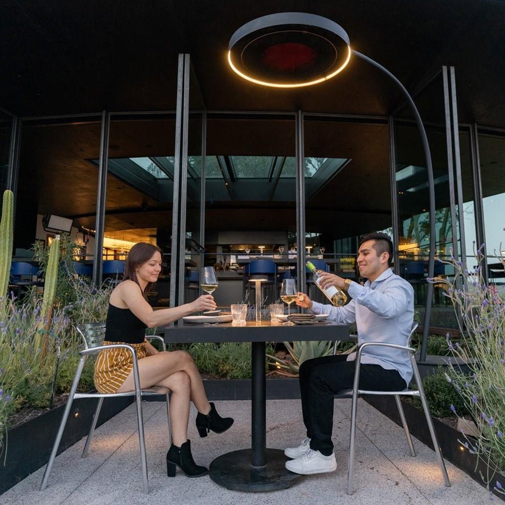 Bromic Eclipse heater in a commercial outdoor dining space with two people seated