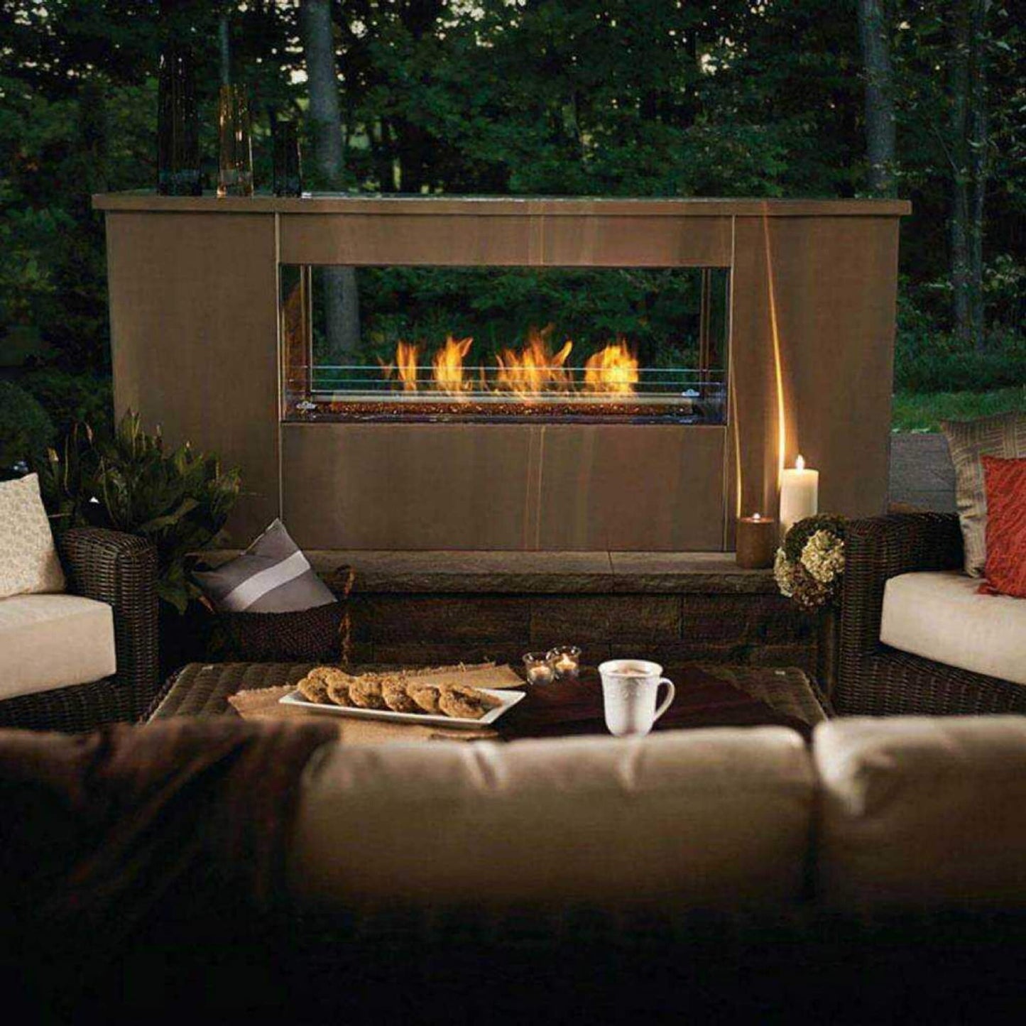 Napoleon Galaxy 48 outdoor linear gas fireplace installed in a modern patio setting with night lighting.